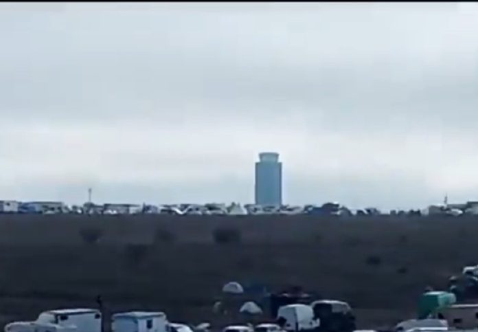 Cientos de caravanas ocupan los terrenos próximos al aeropuerto de Ciudad Real, para una "rave". Al fondo, la torre de control.